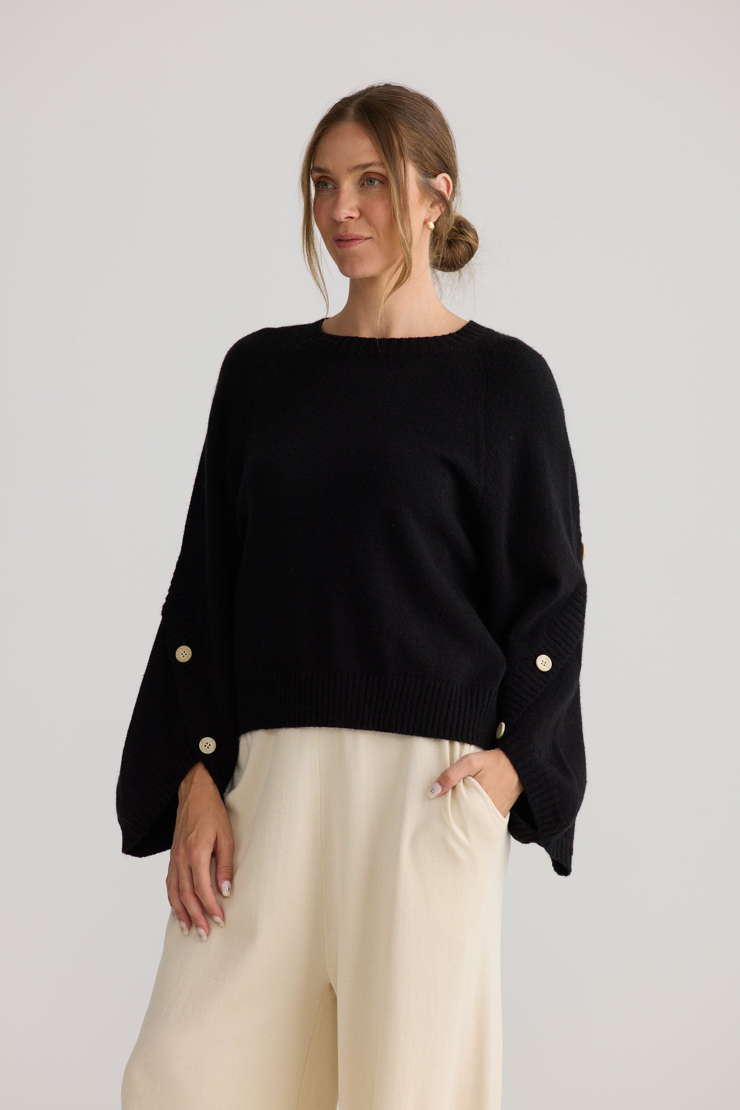 Model wearing Horizon Knit in black, showing knit texture.