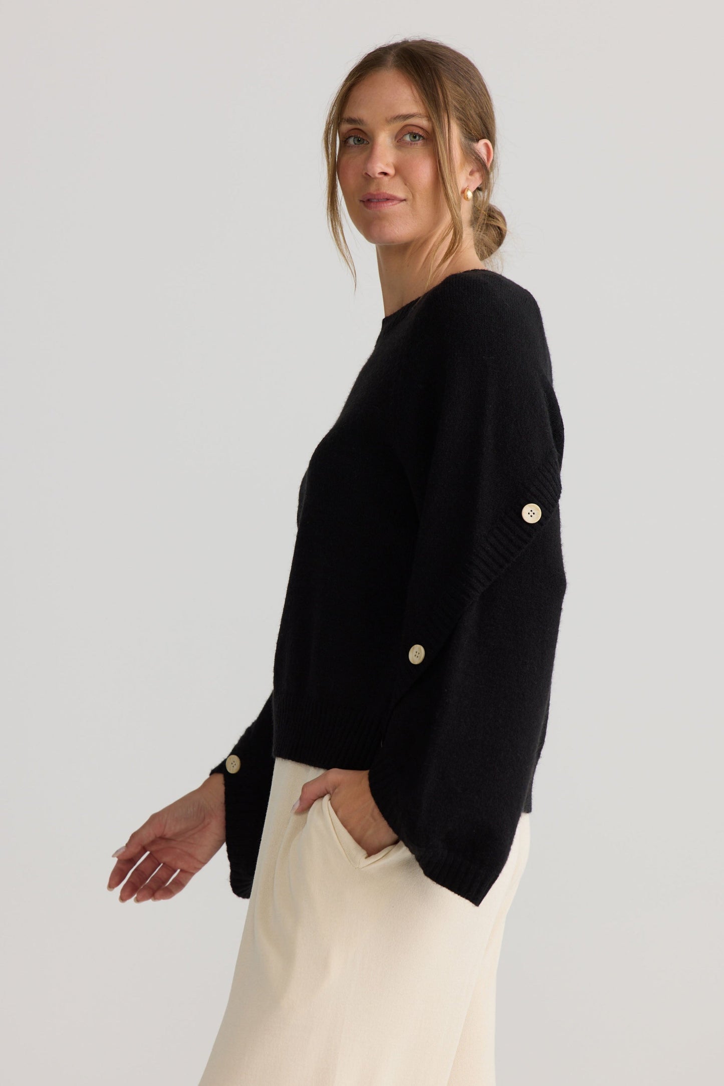 Model wearing Horizon Knit in black, styled for everyday wear.