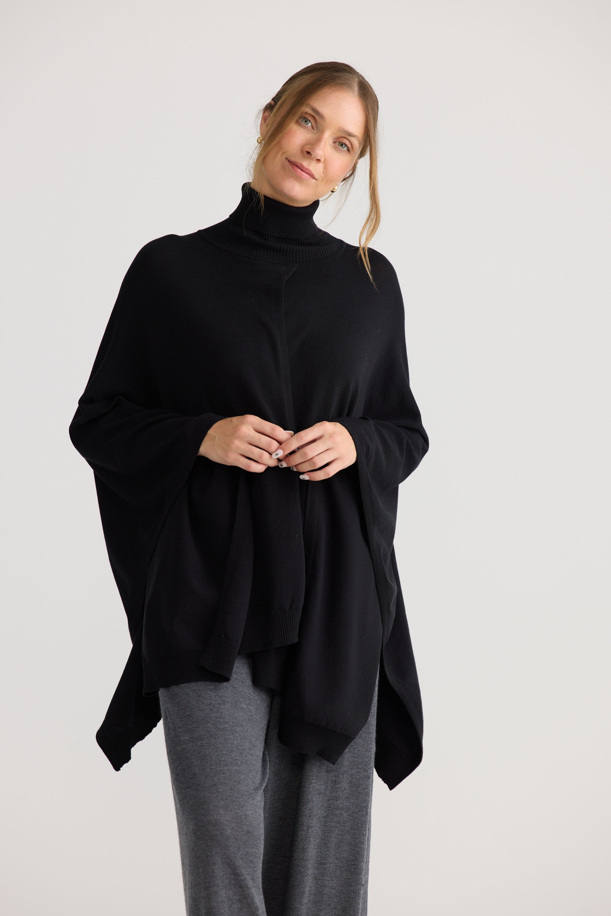 Awaken Knit Cape in black, shown on model.