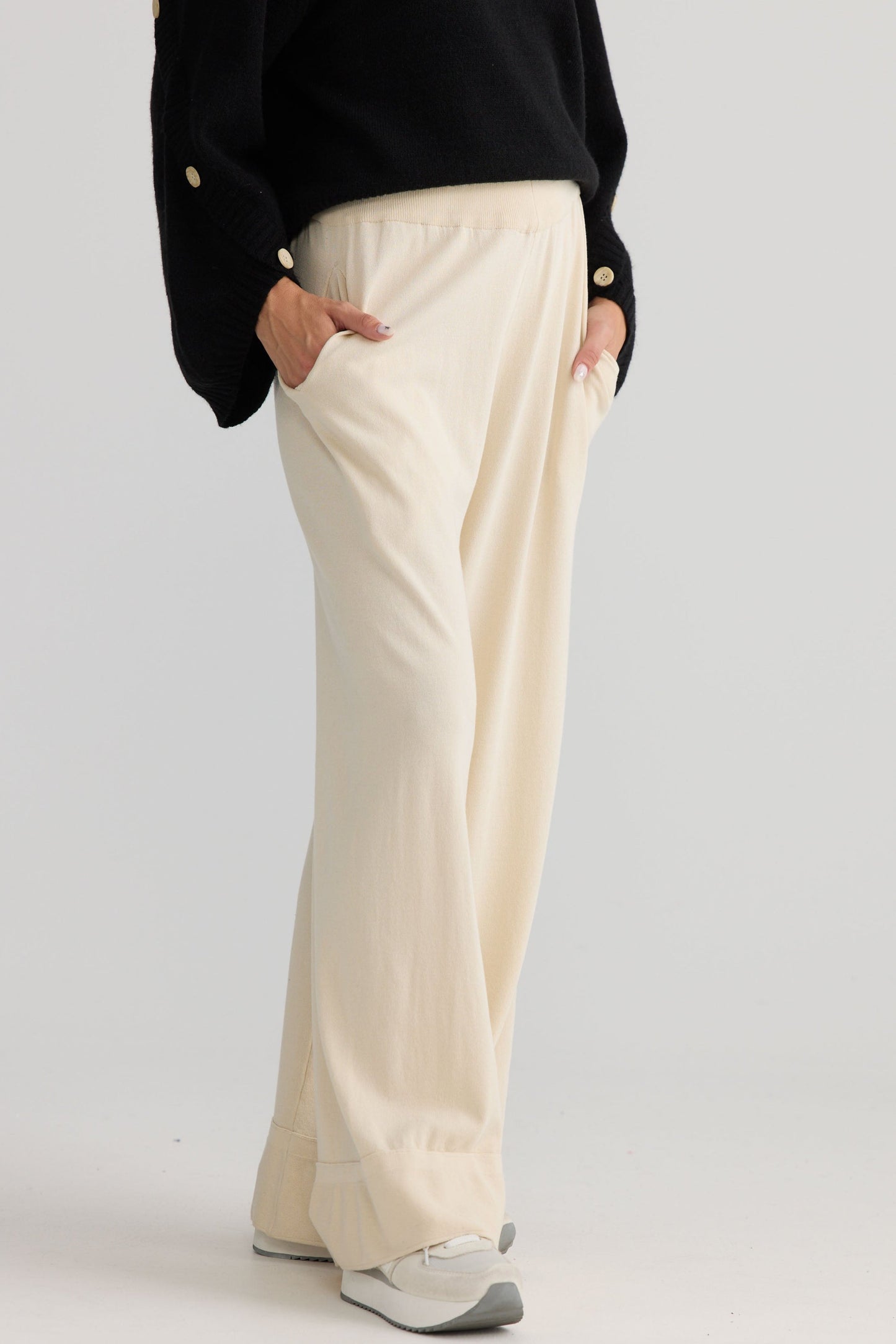Model wearing Awaken Knit Pant in dove, showing relaxed leg shape.