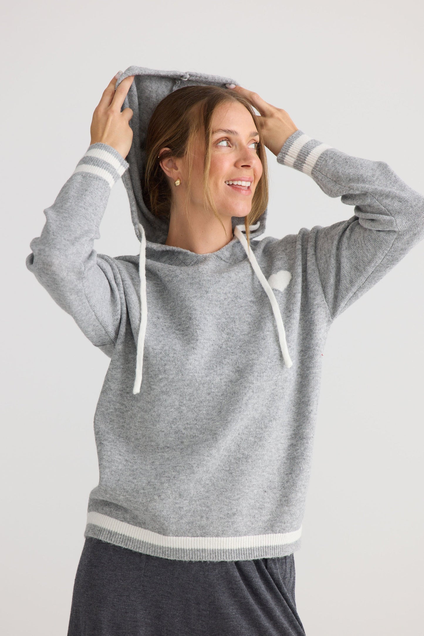 Model wearing Bold Hearts Hoodie in grey.