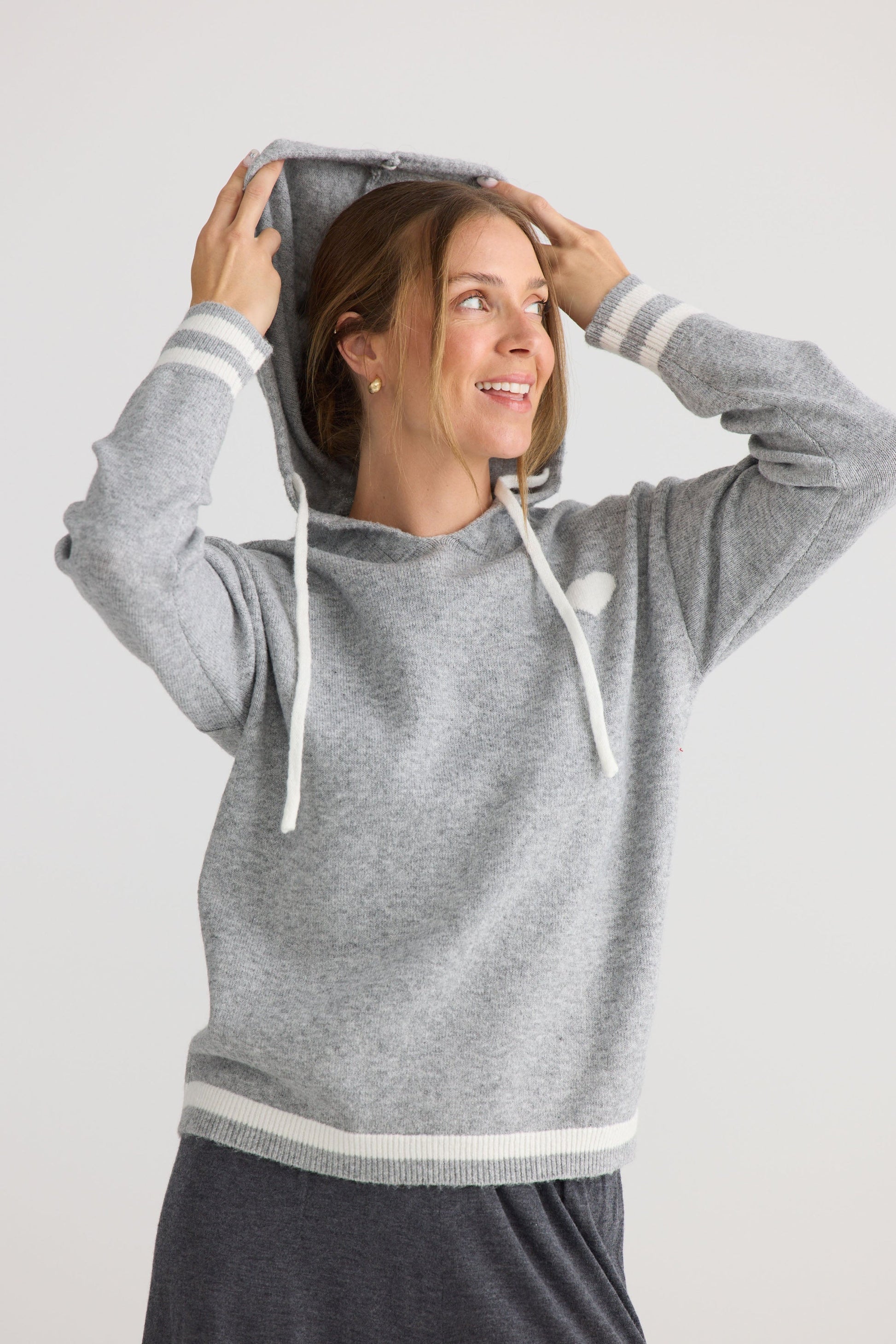 Model wearing Bold Hearts Hoodie in grey.