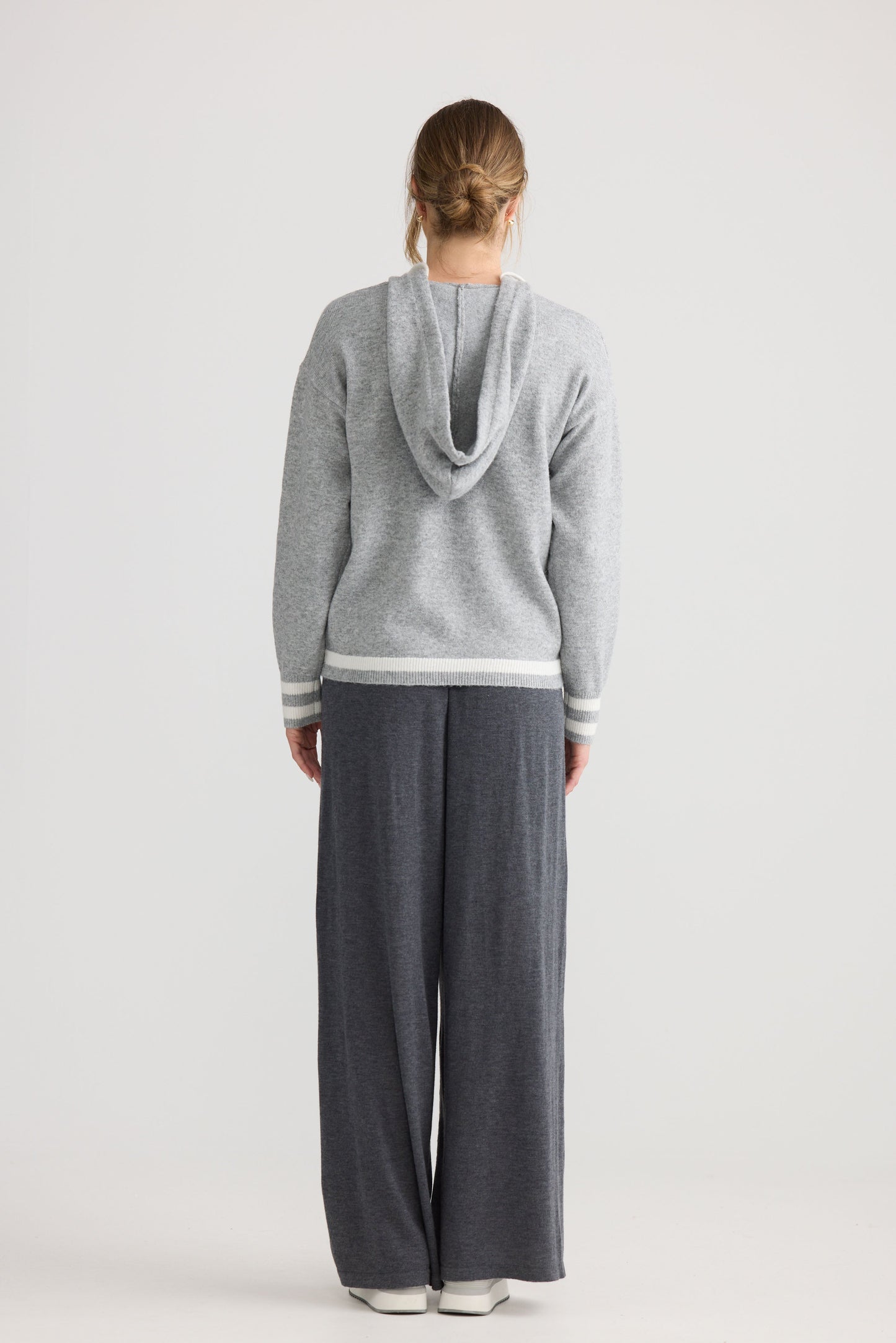 Model wearing Bold Hearts Hoodie in grey, styled for everyday wear.