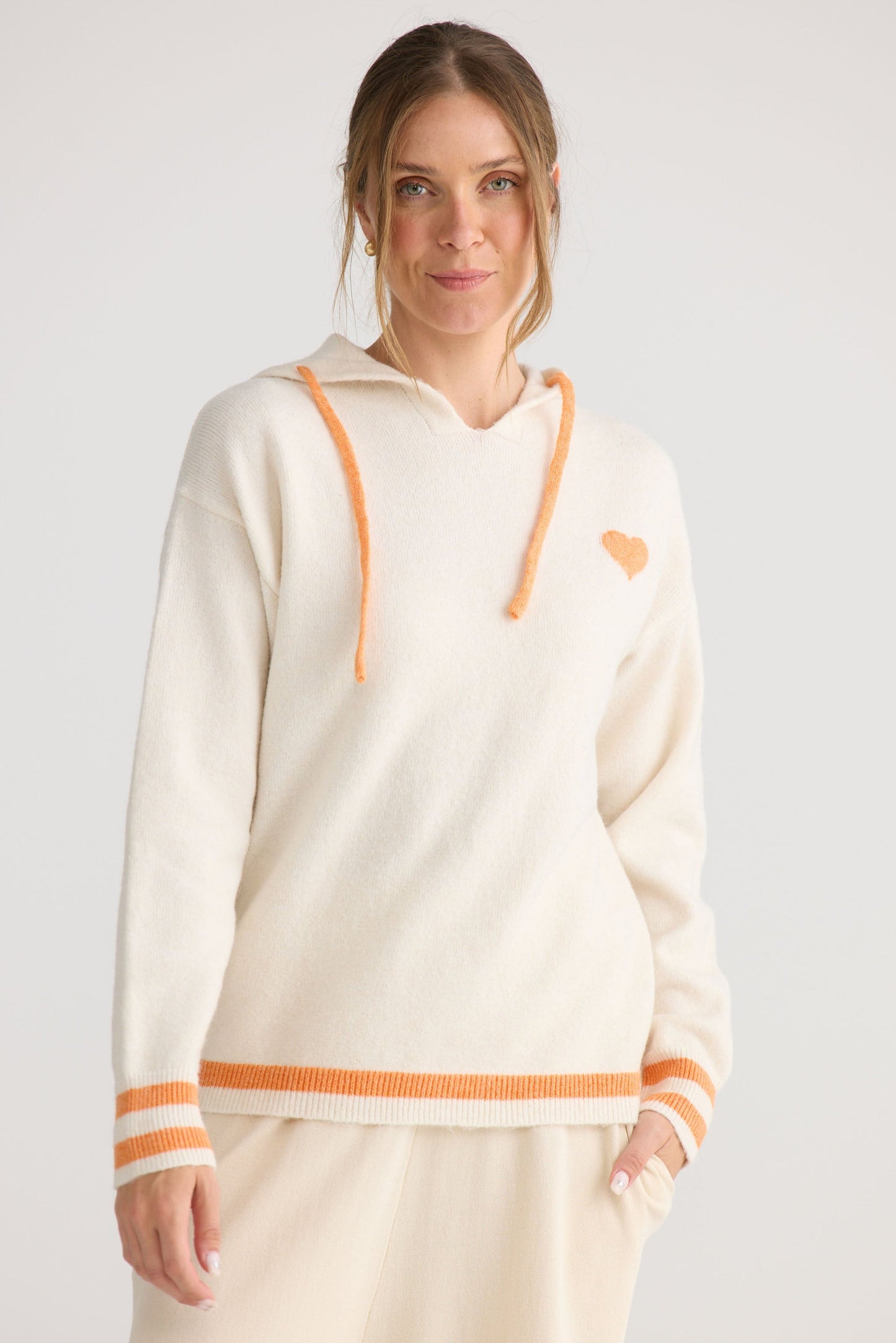 Bold Hearts Hoodie in off white, styled with a relaxed outfit.