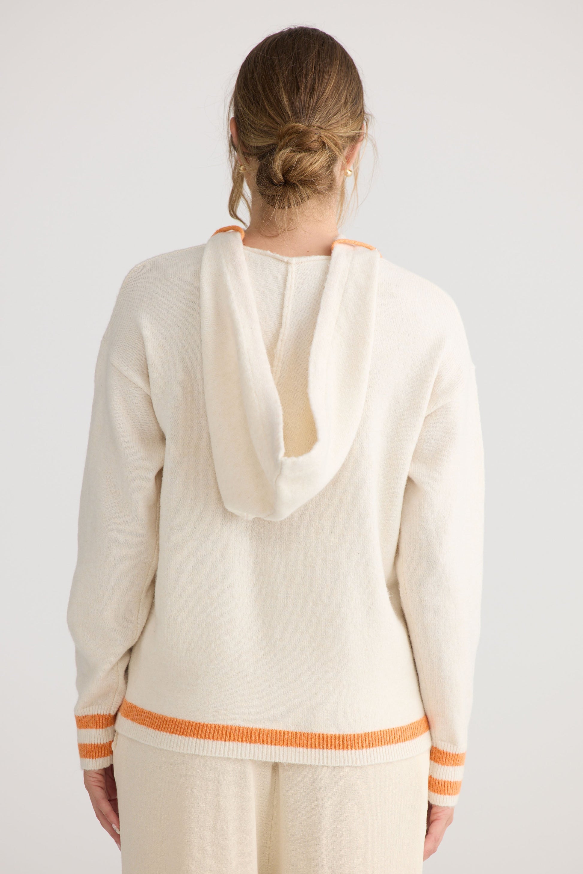 Model wearing Bold Hearts Hoodie in off white.