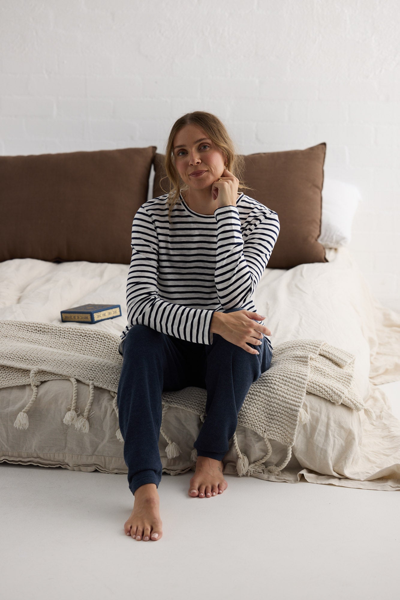 Campaign image of model wearing Sana LS Top in navy stripe.